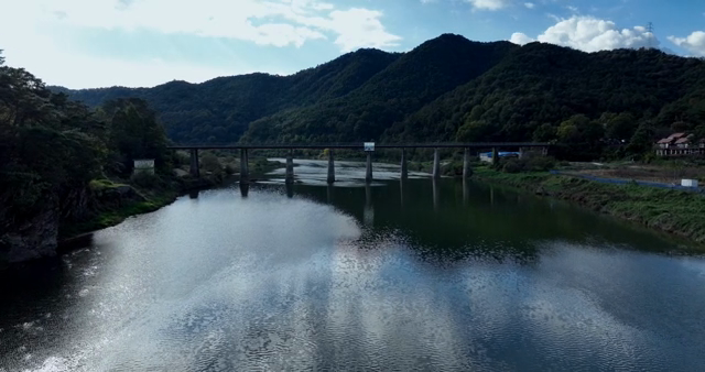 A tranquil river flowing under a bridge