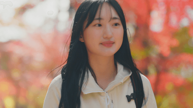 Young woman smiling while hiking in autumn forest
