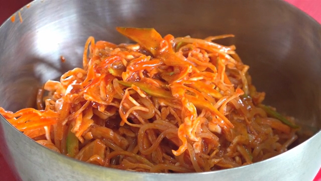 Egg placed on top of vegetable-loaded chewy noodles