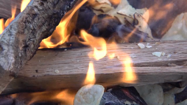 Potato chips burning with charcoal