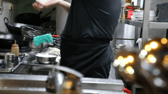 Chef preparing food in a busy kitchen