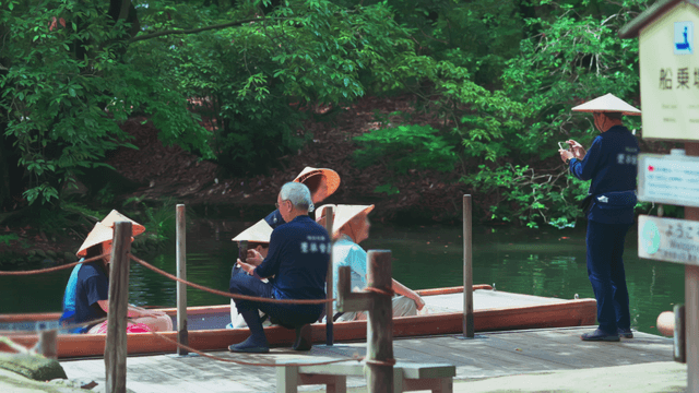 People on a boat in a lush green park