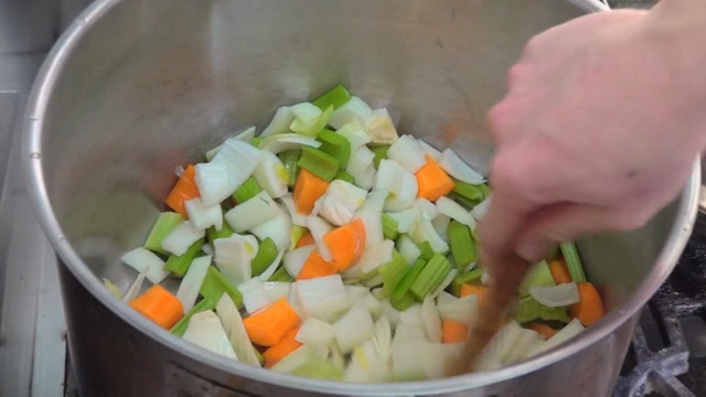 Vegetables being stirred in a pot