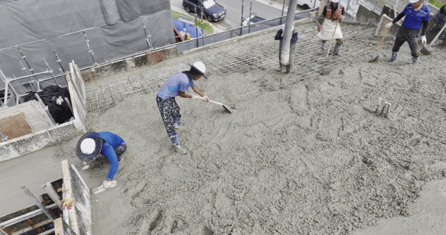 Workers pouring concrete on a building site