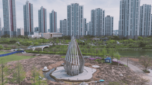 Lake park between tall buildings in modern city