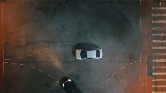 Cars drifting at an empty intersection