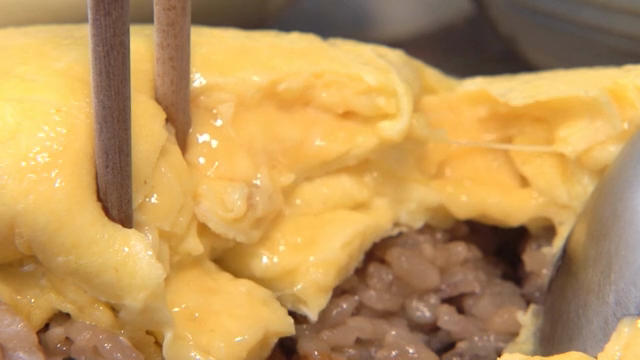 A fluffy omelette being sliced open
