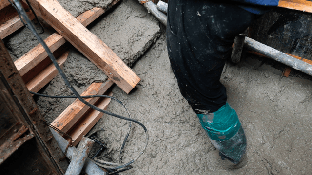 Worker in rubber boots at a construction site