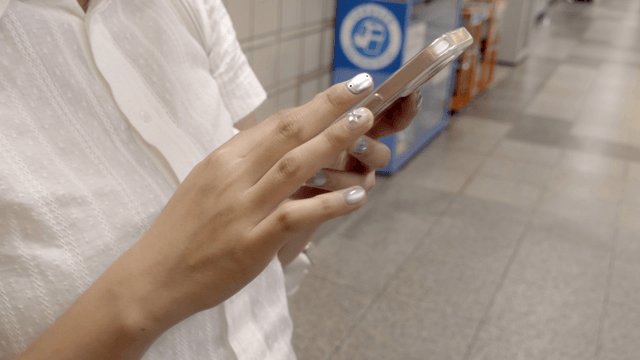 Person using a smartphone in a subway