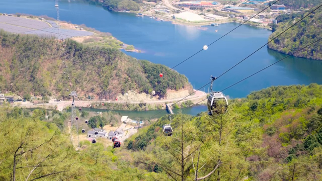 Cable cars over a scenic mountain landscape