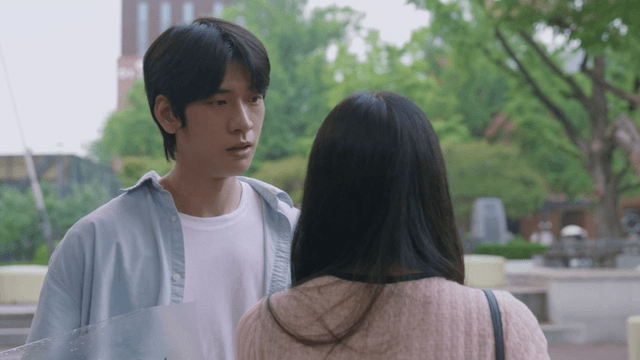 Man holding flowers and a woman leaving