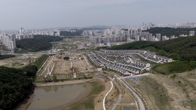 A sprawling cityscape with surrounding hills