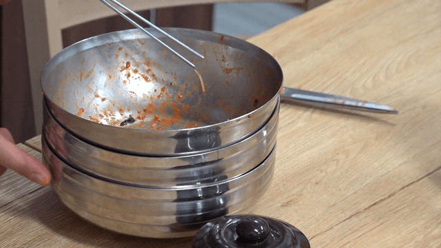 Stacked empty stainless naengmyeon bowls after meal