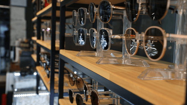 Sunglasses displayed on wooden shelves