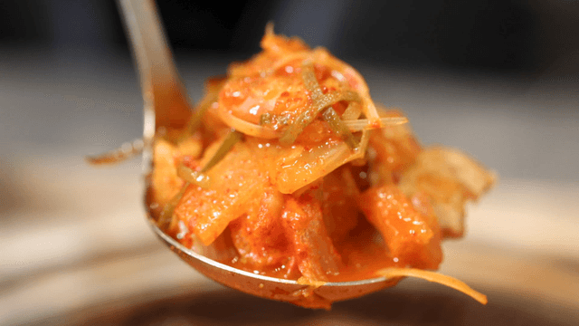 Ladle serving hot kimchi stew