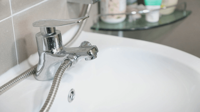 Clean bathroom sink with a shiny faucet