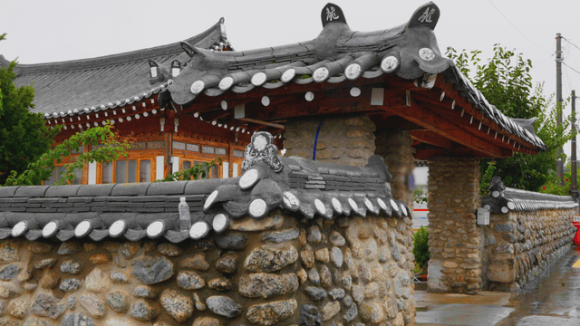 Traditional Korean house with stone wall in rainy day