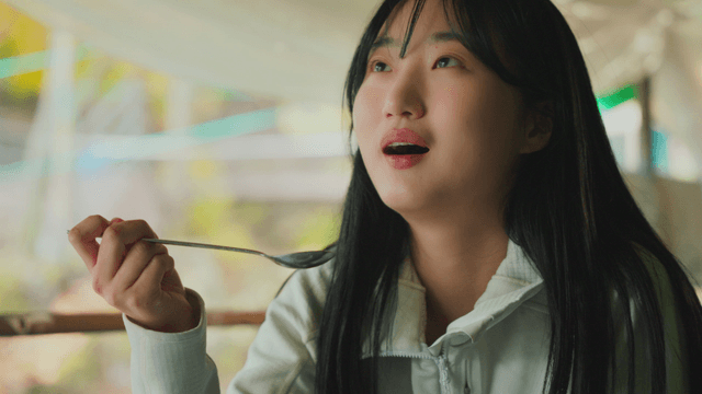 Young woman eating warm soup in forest lodge
