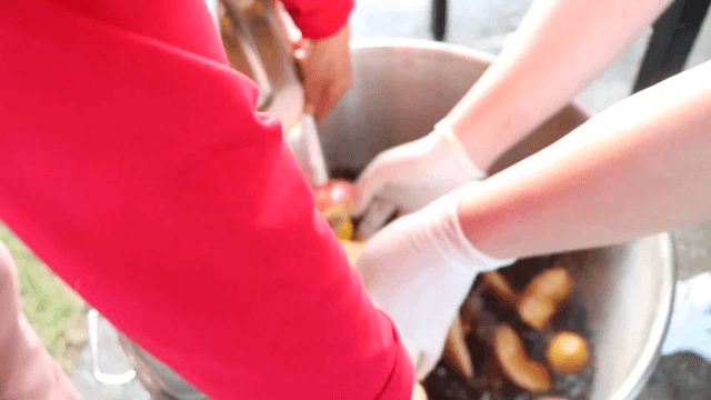 Adding fruit to a pot with soy sauce