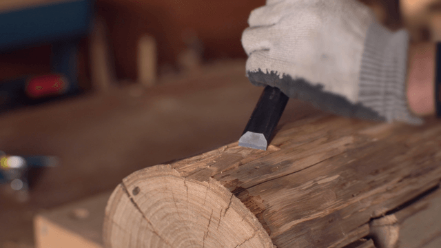 Carving wood with a chisel and mallet