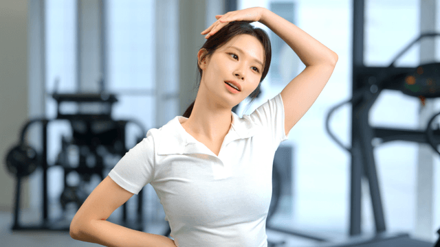 Woman stretching neck at gym