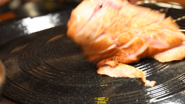 Pork jowl cooking on a hot pan