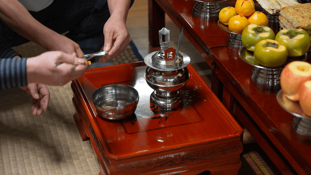 Traditional ritual burning memorial paper on ancestral table