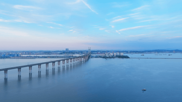 Long bridge stretching over calm sea