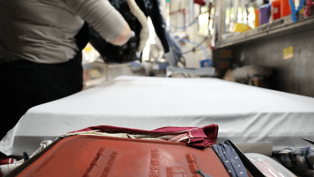 Person ironing clothes in a laundry shop