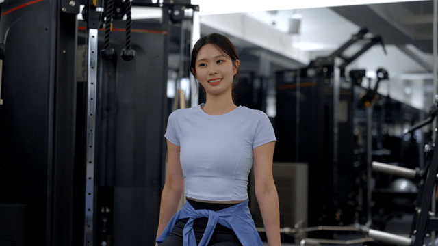 Young woman smiling during a workout break at gym