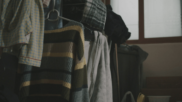 Clothes hanging in a dimly lit room
