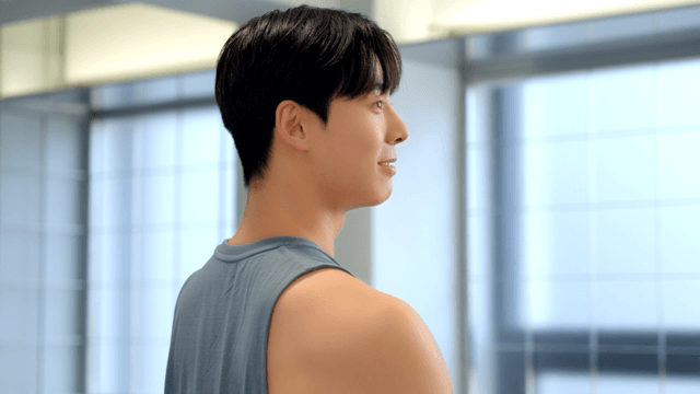 Smiling side profile of a man in bright room