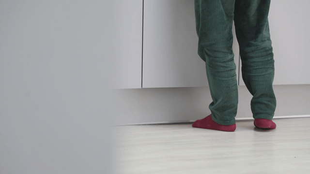 Person standing in front of a cabinet