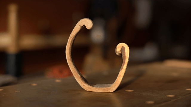 Semi-circular wooden piece on workbench