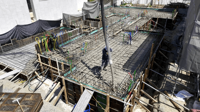 Construction worker pouring concrete