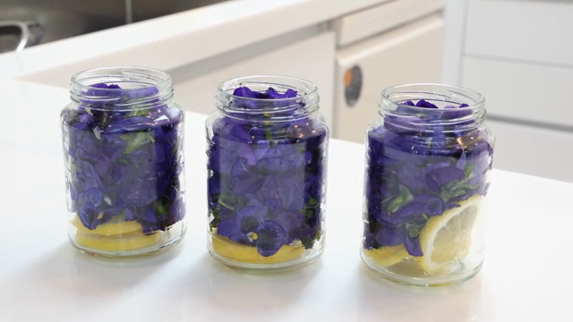 Jars filled with purple flowers and lemon slices