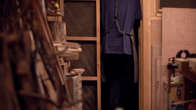 Person entering a wooden workshop