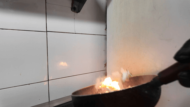 Vegetables stir-fried in a flaming wok