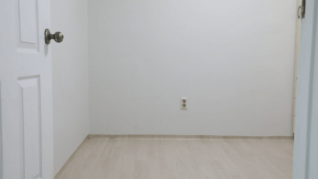 Empty room with a white door and outlet