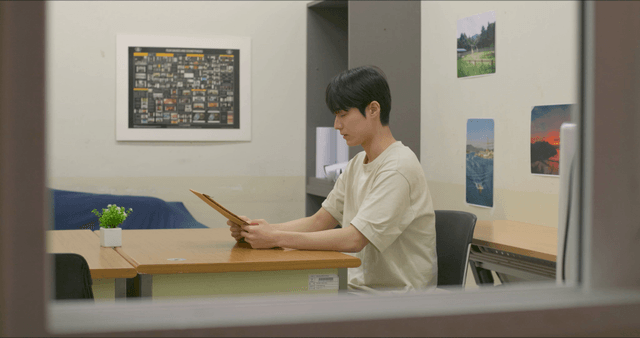 Man looking at envelope indoors