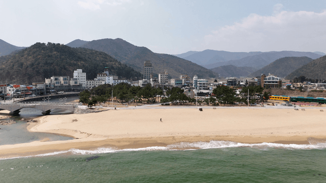 Coastal town with mountains and a beach