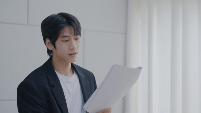 Man presenting indoors with documents