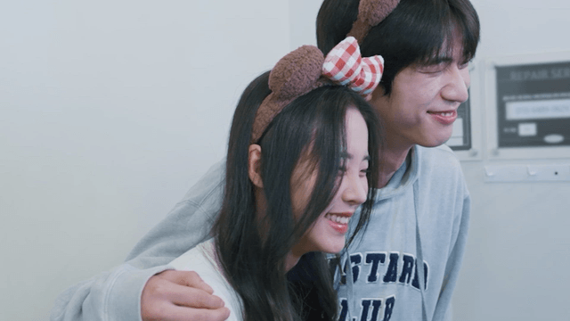 Happy couple taking pictures smiling at an instant photo studio.