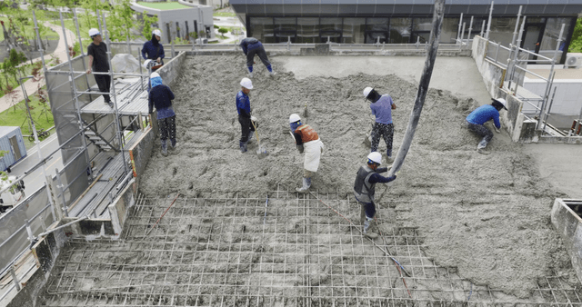 Workers pouring concrete on a building site