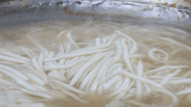 Chicken noodle soup boiling in a pot