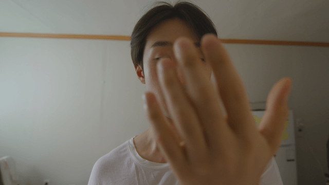 Man looking at his hand indoors