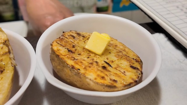 Grilled potato with butter in a bowl