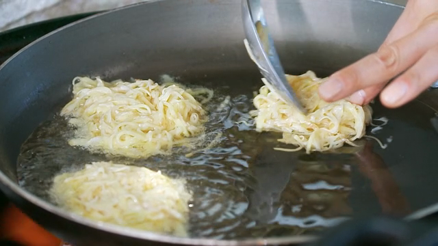 Potato pancakes frying in a pan