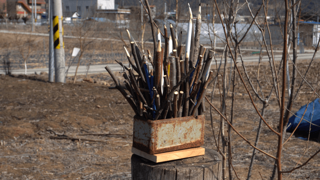 Wooden pencil carving on rural background
