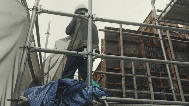 Worker on scaffolding at a construction site